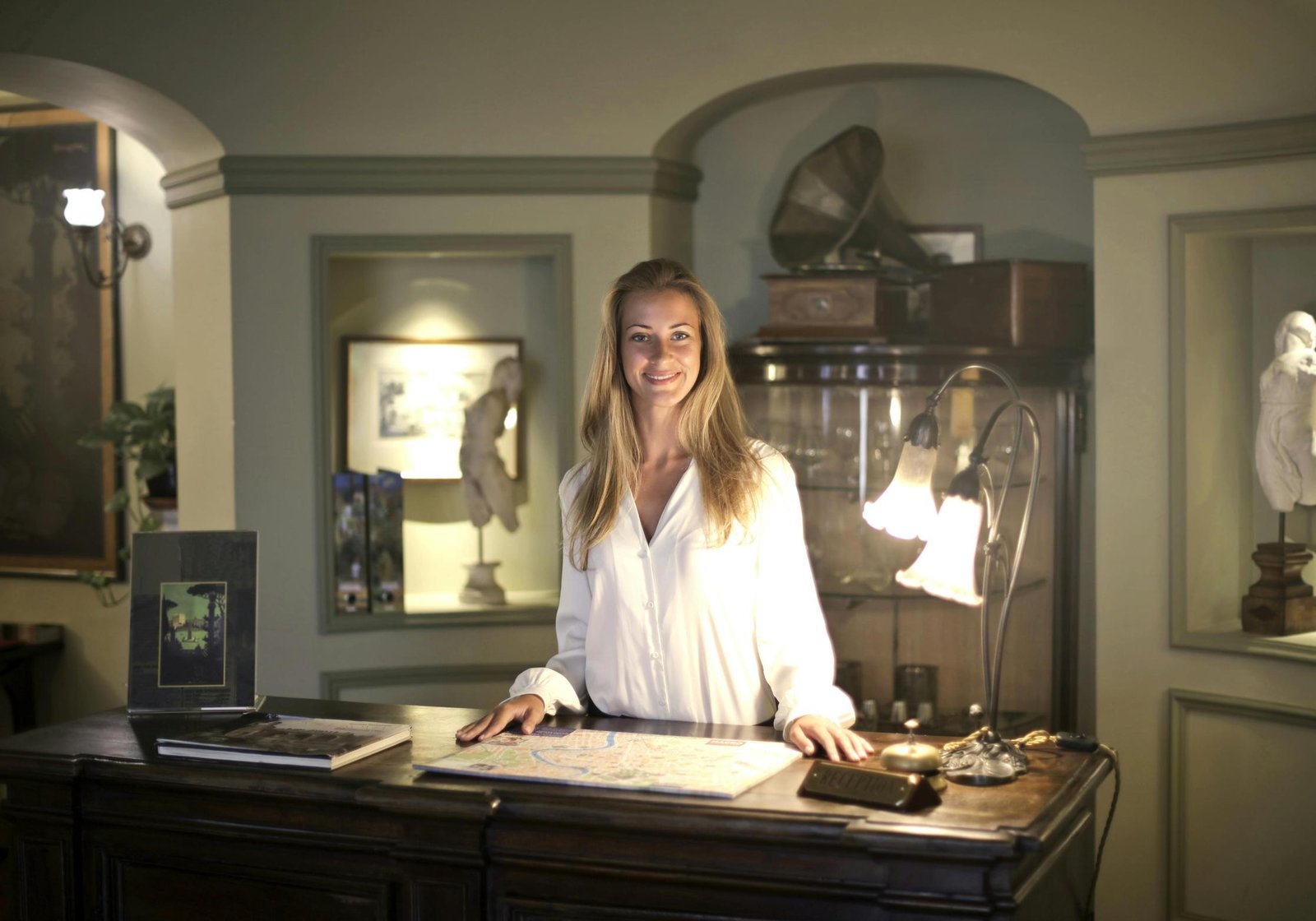 Hotel front desk with staff helping guest